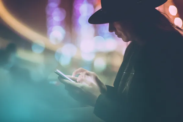 A woman in a luxurious green gown next to an ornate roulette wheel, capturing the upscale casino mood of ZBZBET.